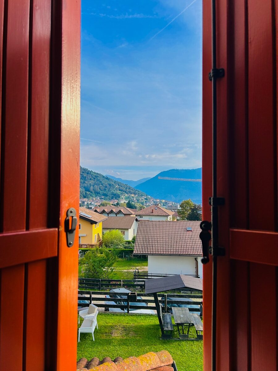An open door leading to a patio with a view of the mountains